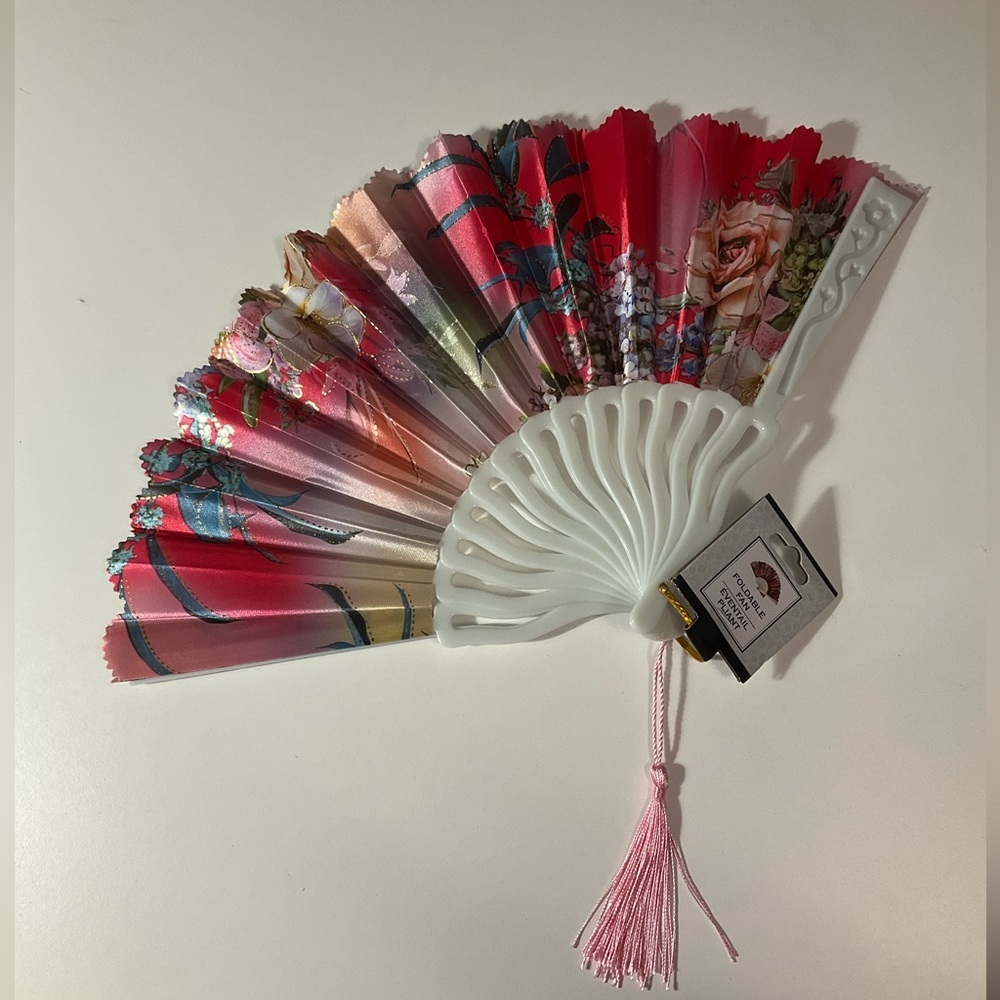 New with tags! Foldable fan! Pinks/greens/gold.